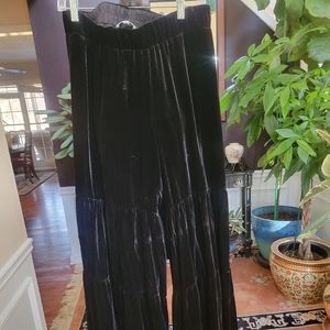 Johnny was jade velvet tiered black pants.